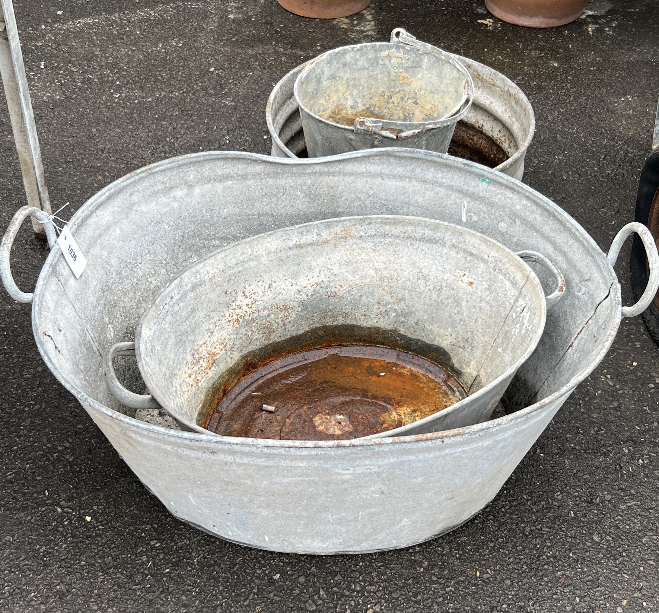 Four vintage galvanised buckets and containers, largest width 83cm, depth 60cm, height 37cm